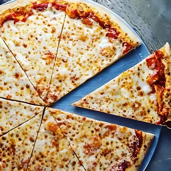 A freshly baked, sliced cheese pizza with a missing slice, on a blue plate.