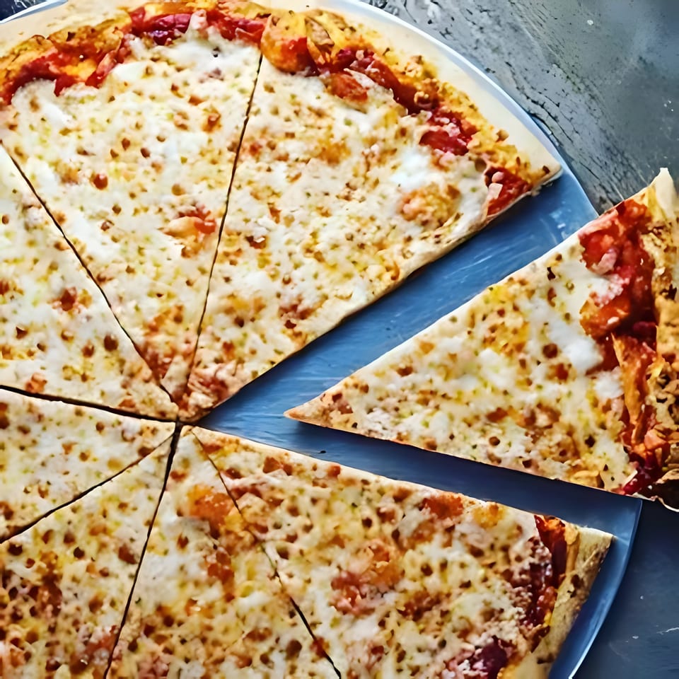 A freshly baked, sliced cheese pizza with a missing slice, on a blue plate.