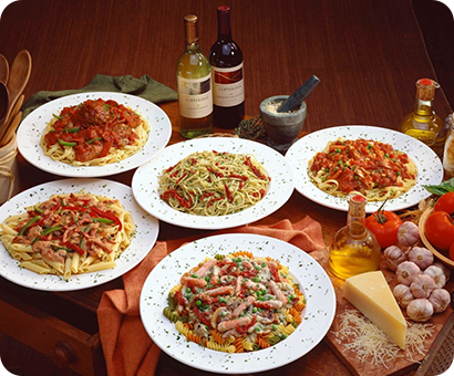 A table with several plates of food on it.